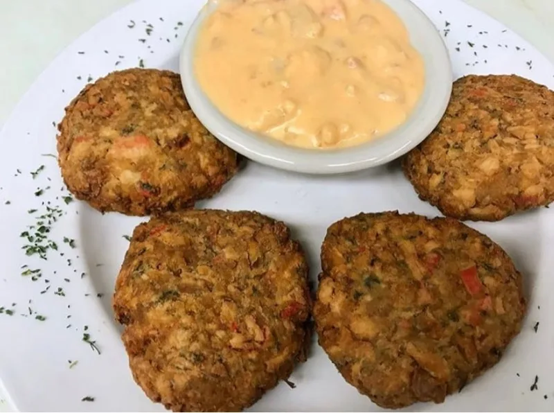 Homemade crab cakes with seafood bisque dip